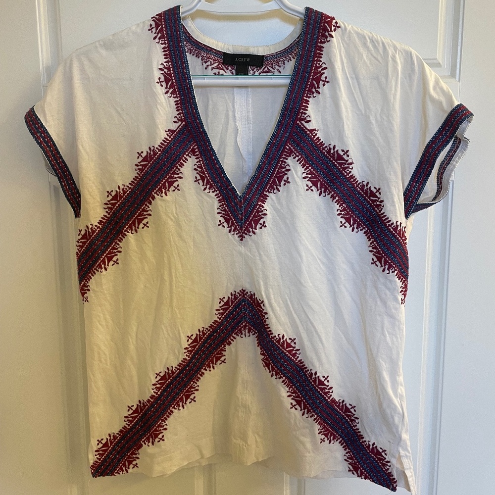 White top with embroidery detail.
